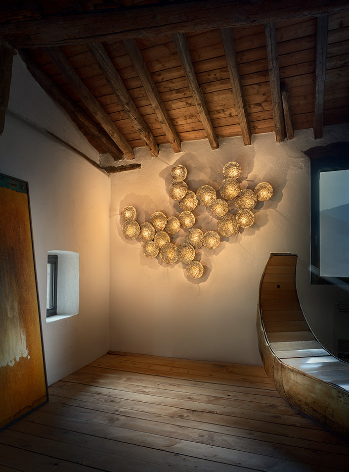 Catellani & Smith Gold Moon, multi-disc wall composition under a timber roof