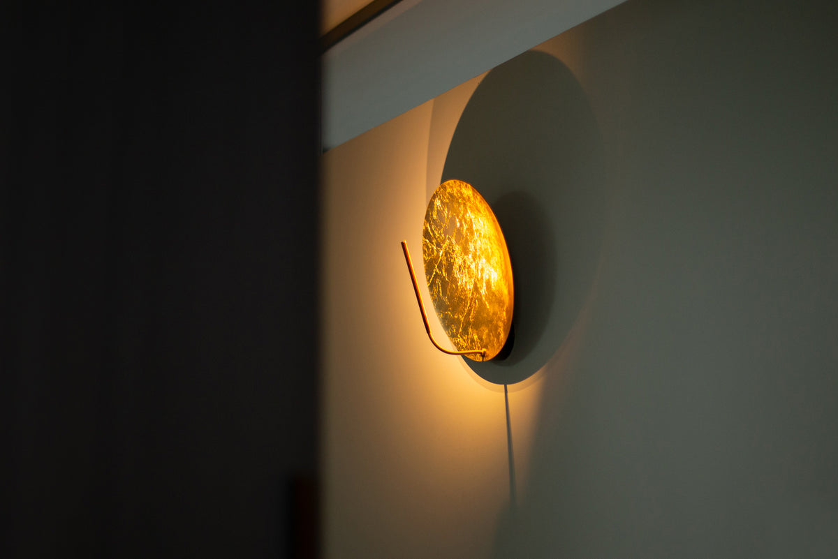 Catellani & Smith Luna Wall Lamp 30 on a dark green wall