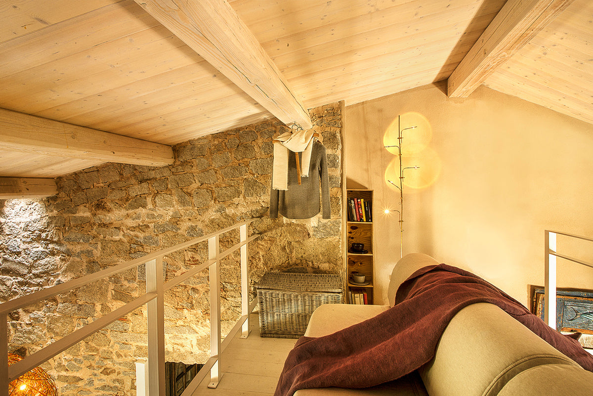 Catellani & Smith Wa Wa Floor Lamp in a stone walled interior