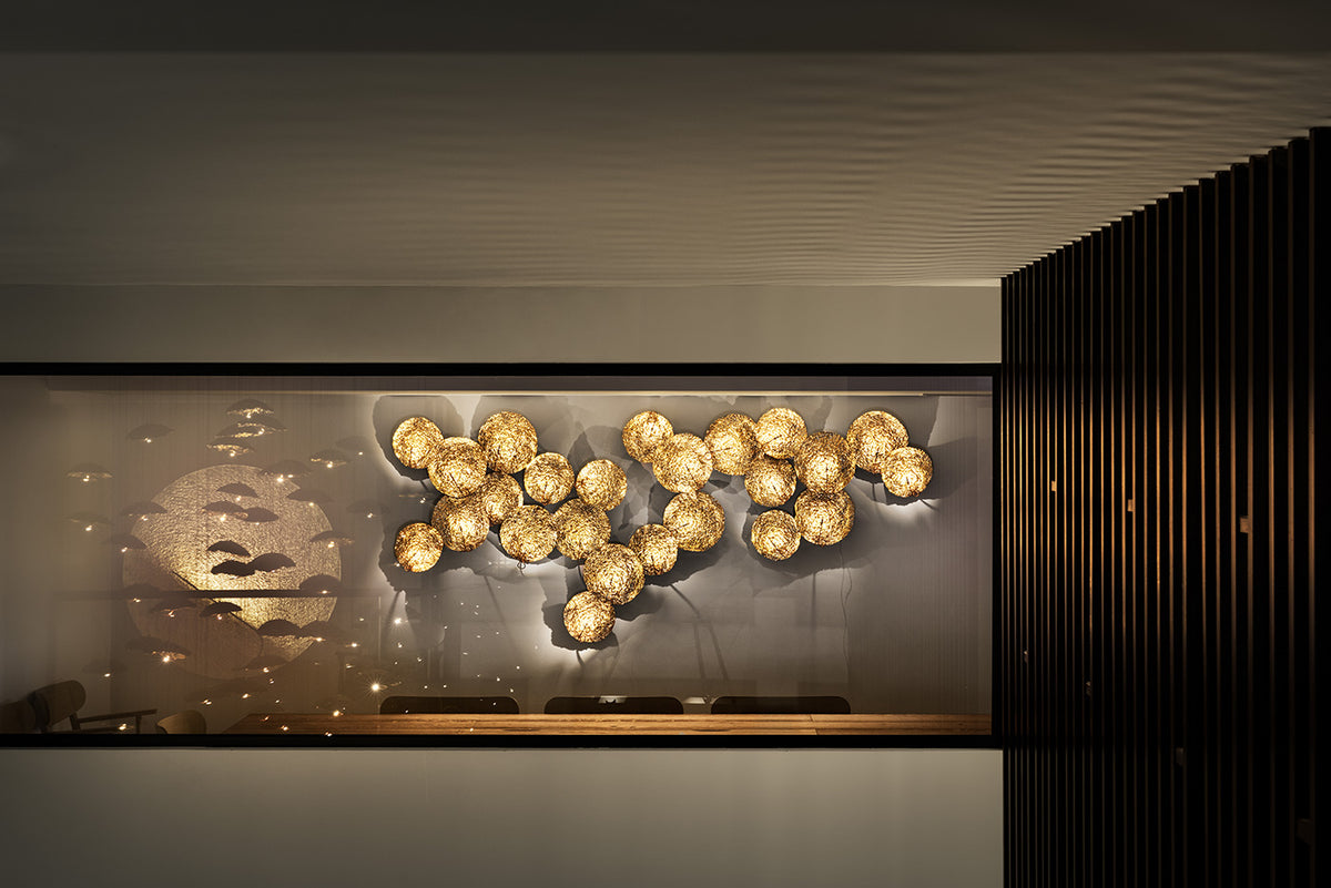 Catellani & Smith Gold Moon, multi-disc wall composition behind glass