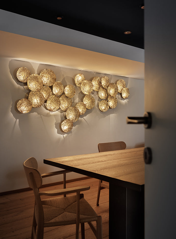 Catellani & Smith Gold Moon, multi-disc wall composition above a dining table