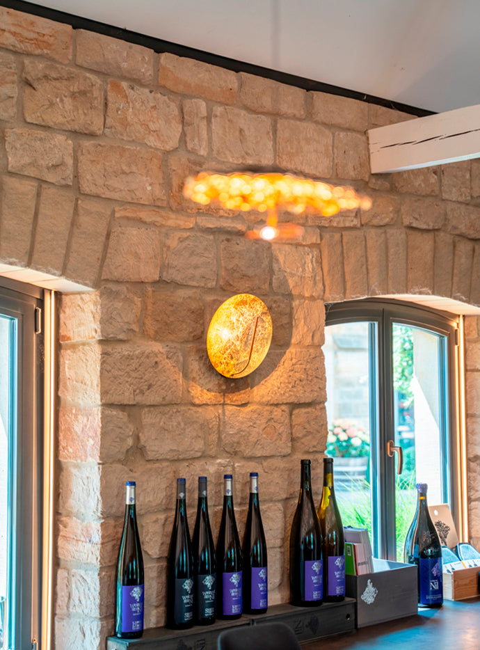 Catellani & Smith Luna Wall Lamp 30 in a stone walled bar